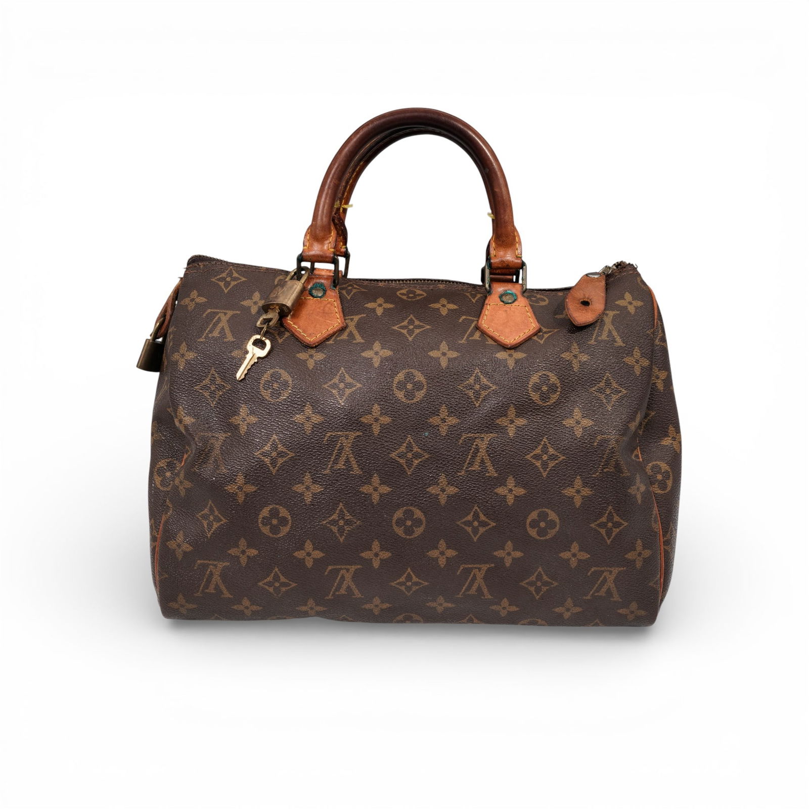 Louis Vuitton Monogram Canvas Speedy Handbag with Padlock & Key: Louis Vuitton Monogram Canvas Speedy Handbag with Padlock & KeyCirca Late 20th century, FranceA classic Louis Vuitton Speedy handbag executed in monogram-coated canvas with natural vachetta leather tr