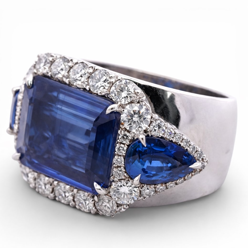 18k Gold Diamonds & Synthetic Sapphire Cocktail Ring: 18k Gold Diamonds & Synthetic Sapphire Cocktail RingCirca Late 20th CenturyAn 18k white gold cocktail ring set with a large rectangular step-cut blue SYNTHETIC sapphire measuring approximately 13.5 ×