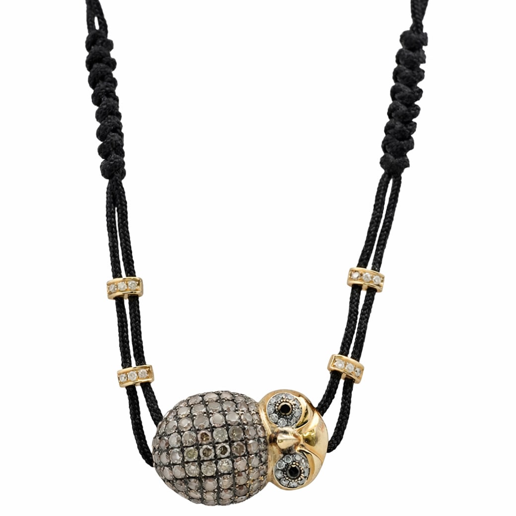 AP 18K Gold & Diamond Owl Bracelet: AP 18K Gold & Diamond Owl Bracelet20th Cent.18k yellow gold owl pendant bracelet with pave diamond inset design, crafted with ruby eyes, fitted further gold and diamond insets on a black nylon strand.