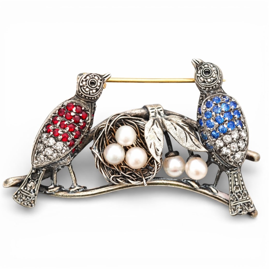Silver Gilt Ruby Sapphire Diamond & Pearl Bird Brooch: Silver Gilt Ruby Sapphire Diamond & Pearl Bird BroochCirca 1950s-1960s, EuropeanFigural bird brooch constructed in silver with worn gold plating, designed as two birds perched on a curved branch suppo