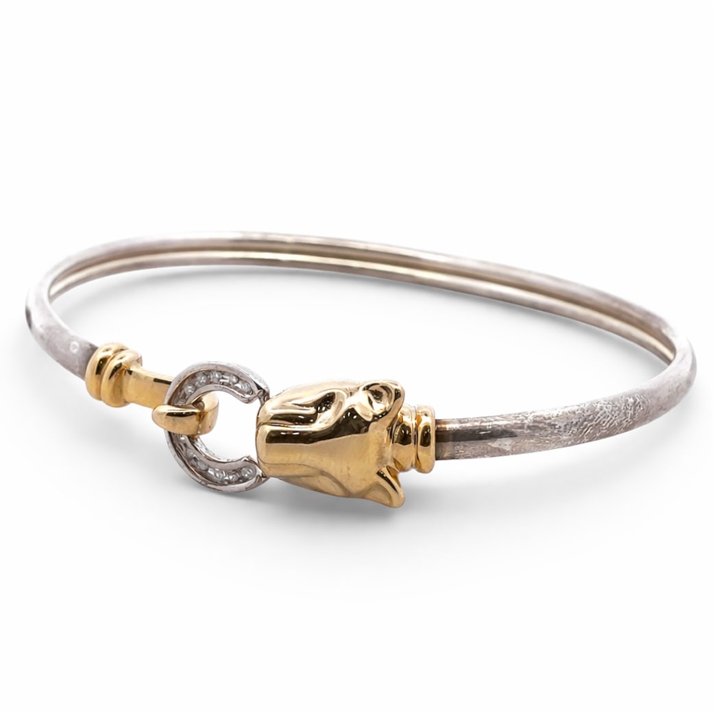 JTL 14k Gold, Diamond, & Silver Panther Bangle: JTL 14k Gold, Diamond, & Silver Panther Bangle 20th Cent. Israel JTL 14k Yellow gold and silver bangle, designed with panther head holding hook and diamond inset ring closure. Marked: '14k, JTL, 925'