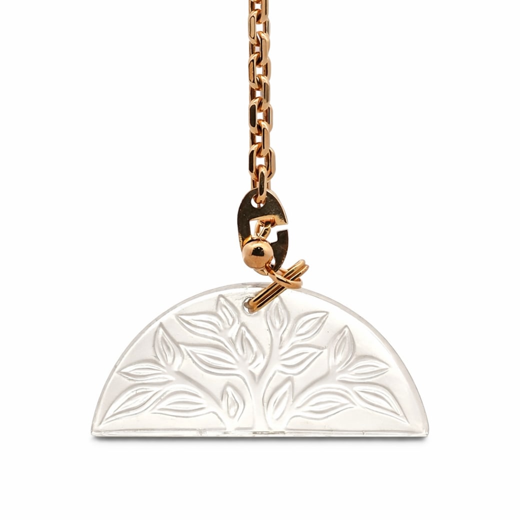 Rene Lalique Crystal Pendent Ornament: Rene Lalique Crystal Pendent Ornament20th Cent. FranceRene Lalique crystal pendent ornament featuring tree of life design, suspended from gold-toned chainlink. Signed: 'R. Lalique France'Pendent: H:24