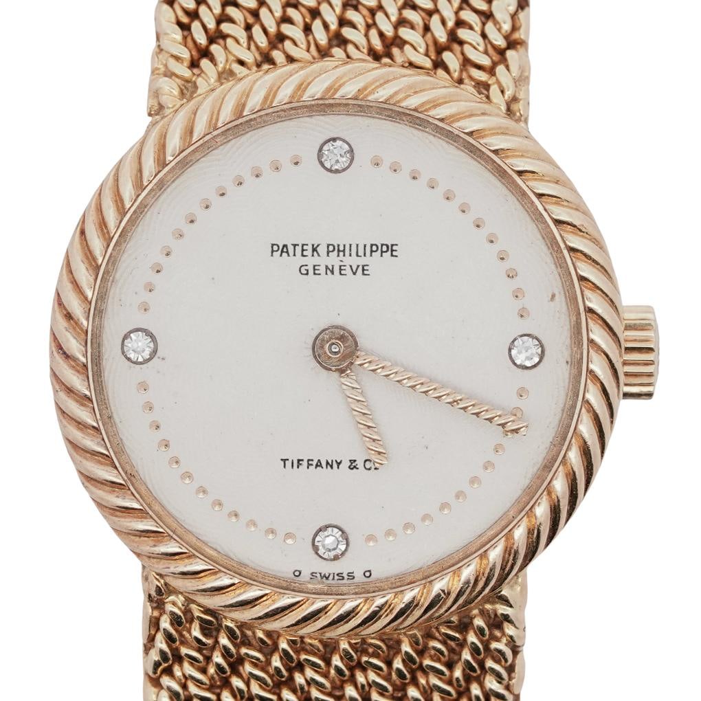 Patek Philippe for Tiffany & Co. 18k Gold Woven Mesh Ladies Watch: Patek Philippe for Tiffany & Co. 18k Gold Woven Mesh Ladies WatchCirca: 1970s, Switzerland.18K yellow gold ladies wristwatch retailed by Tiffany & Co., featuring a guilloché sunburst silvered dial ac
