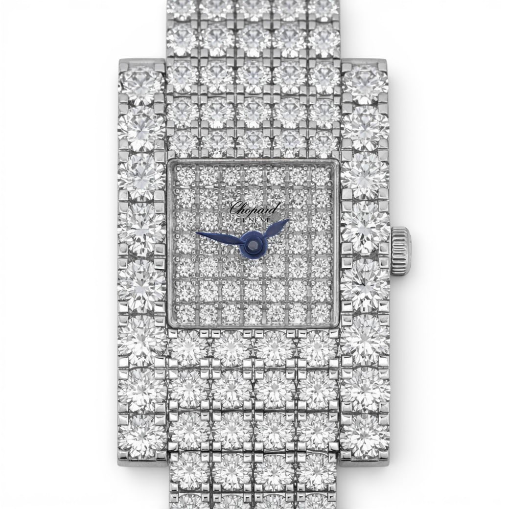 Chopard 18k Gold & Diamond Ladies Watch: Chopard 18k Gold & Diamond Ladies WatchCirca: 2000s, Switzerland.An 18k white gold and diamond wristwatch by Chopard, designed with a rectangular case and integrated bracelet, extensively pavé-set wi