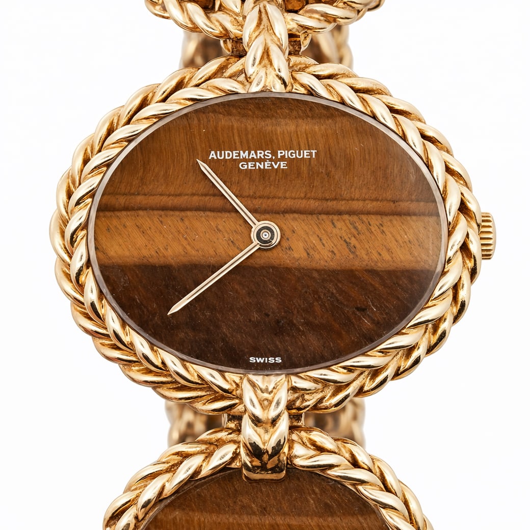 Audemars Piguet For Chaumet 18k Gold & Tiger’s Eye Ladies Watch: Audemars Piguet Vintage 18k Gold & Tiger’s Eye Ladies WatchCirca 1960s, SwissVintage Audemars Piguet Genève ladies dress watch in 18k yellow gold, built as an integrated jewelry bracelet with repea