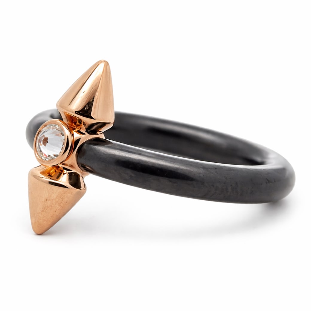 Tiffany & Co. 18k Gold Titanium & Diamond Titan Ring by Pharrell Williams: Tiffany & Co. 18k Gold Titanium & Diamond Titan Ring by Pharrell WilliamsCirca: 2000s, USA.A contemporary Tiffany & Co. Titan ring designed by Pharrell Williams, composed of a matte black titanium ban