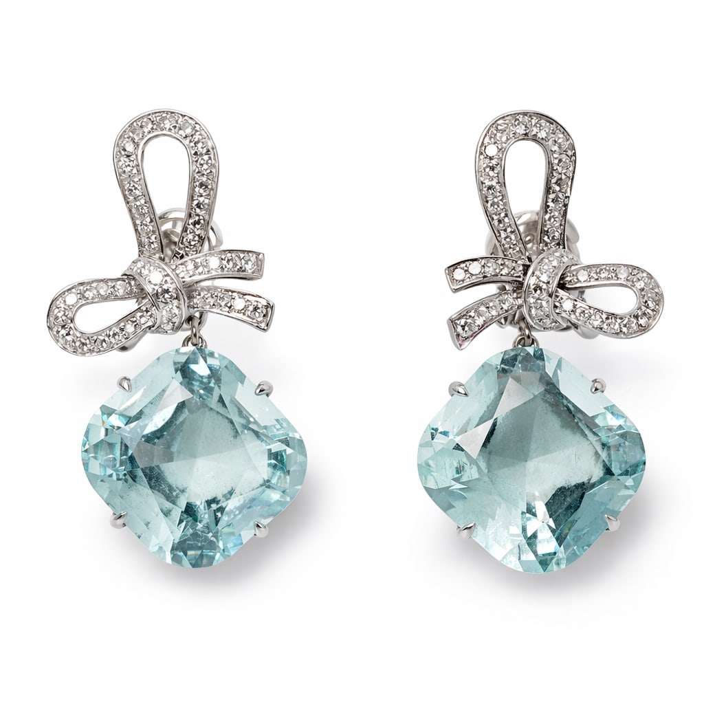 Vintage 18k Gold Aquamarine & Diamond Bow Earrings: Vintage 18k Gold Aquamarine & Diamond Bow EarringsCirca: 1990s, Italy.Vintage Pair of 18k white gold bow-form earrings, each suspending a cushion-cut light aquamarine (approx. 7–8ct each; total aqua