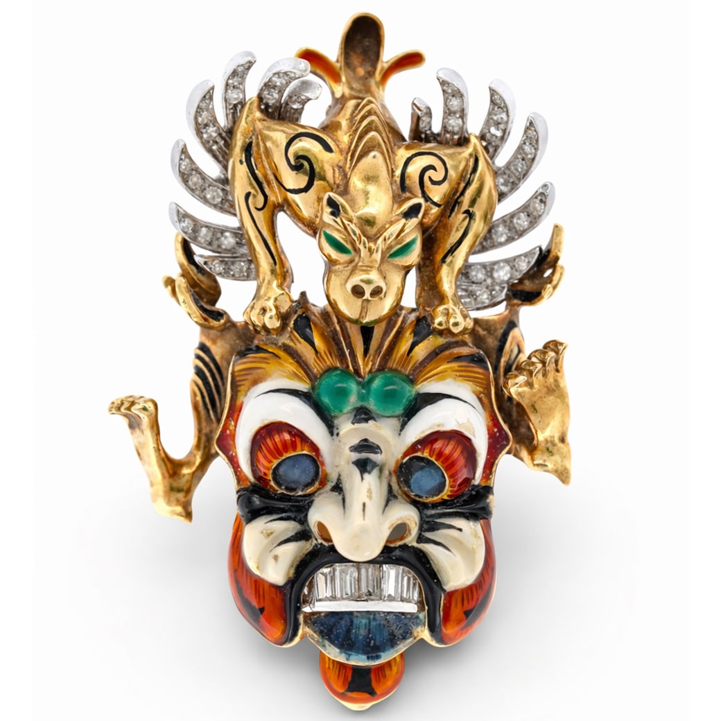 18k Gold Diamond Sapphire & Enamel Balinese Mask Brooch Signed: 18k Gold Diamond Sapphire & Enamel Balinese Mask Brooch SignedCirca 1975-1990, Italy.18k yellow gold Balinese guardian mask brooch, richly finished with polychrome enamel and intricate chased detailin
