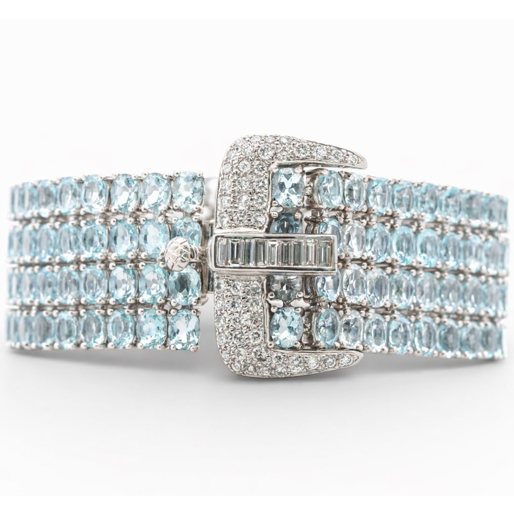 H. Stern 18k Gold Diamond & Topaz Belt Bracelet: H. Stern 18k Gold Diamond & Topaz Belt BraceletCirca: 1990s, Italy.18k Wide multistrand bracelet by H. Stern, composed of five continuous rows of oval faceted blue topaz, totaling approximately 130.0
