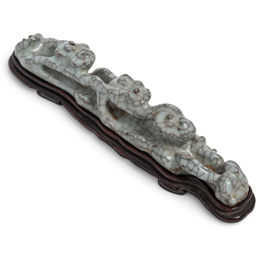 Antique Chinese Guan Ware Porcelain Brush Rest: Antique Chinese Guan Ware Porcelain Brush Rest 19th Century, Qing Dynasty, China An antique Chinese Guan Ware porcelain brush rest modeled as a rockwork base, covered in a pale celadon glaze with an a