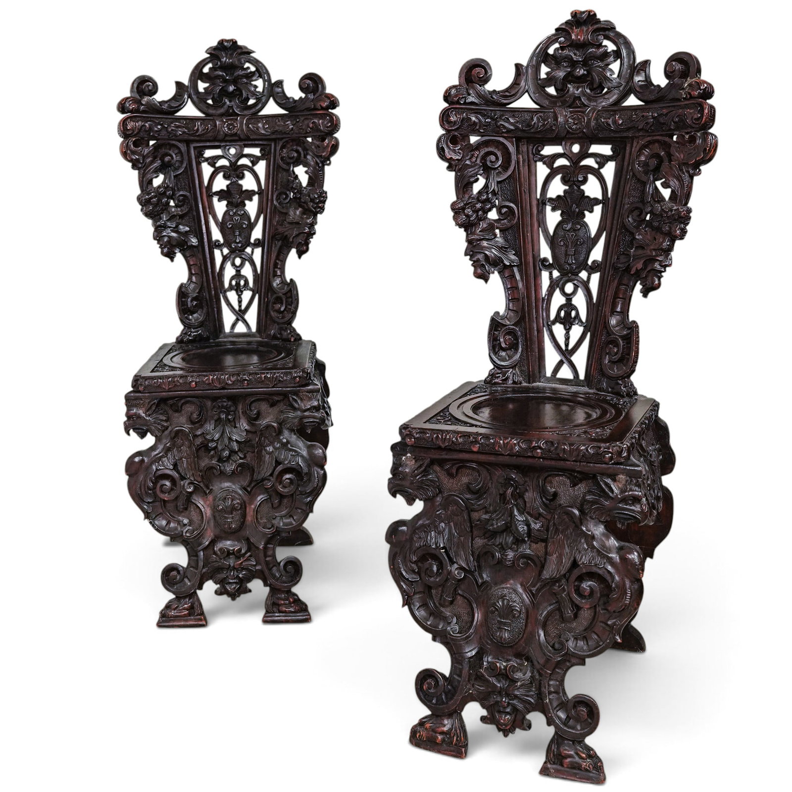 Pair of Italian Renaissance Revival Sgabello Hall Chairs: Pair of Italian Renaissance Revival Sgabello Hall Chairs 19th century, Italian A pair of Italian Renaissance Revival figural sgabello hall chairs, crafted from a heavy dark wood with ornate carvings l