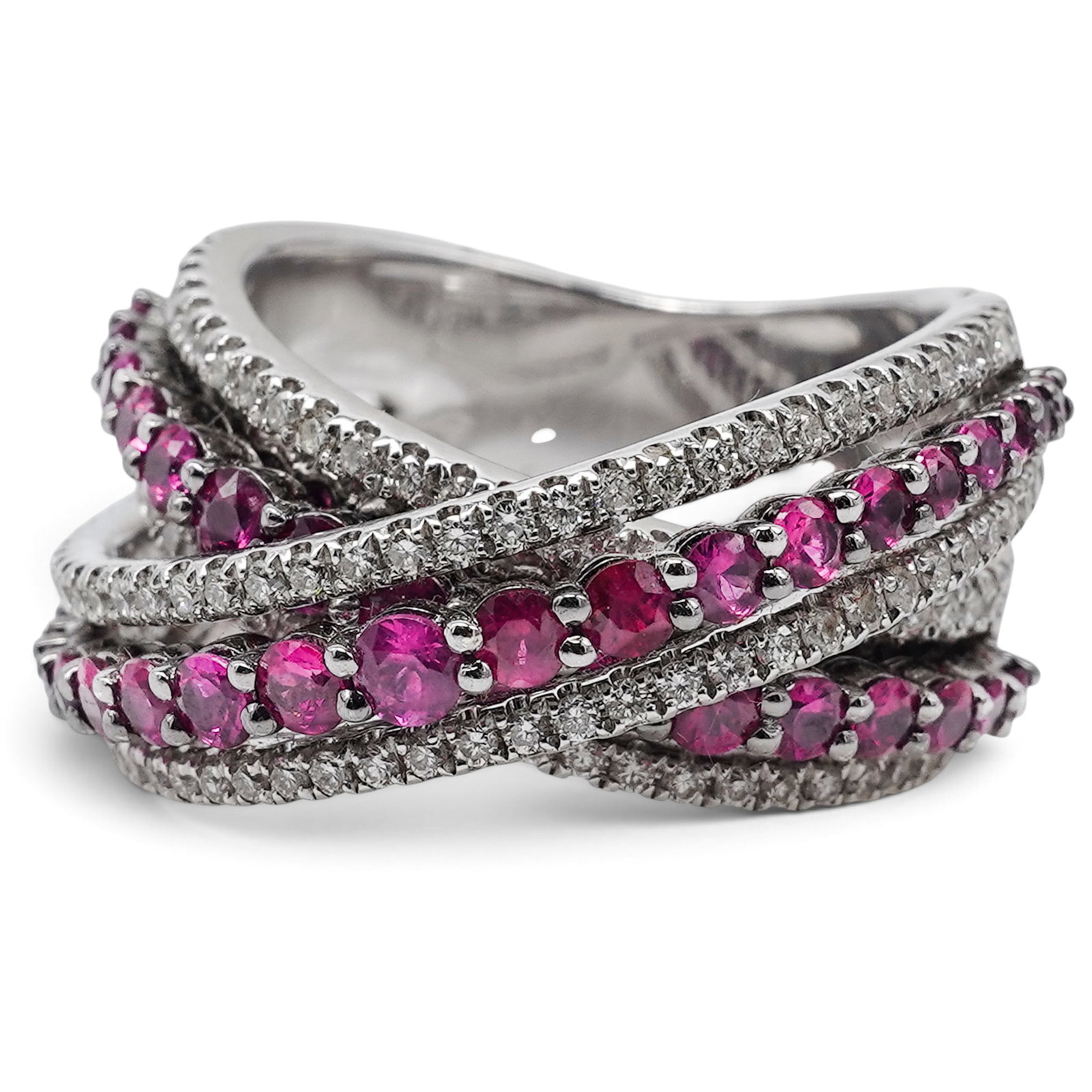 18k Gold Ruby & Diamond Crossover Ring: 18k Gold Ruby & Diamond Crossover Ring 2000s Wide 18k white gold crossover ring designed with interlacing rows of round-cut rubies weighing approximately 2.20 carats total and pavé-set round brillian