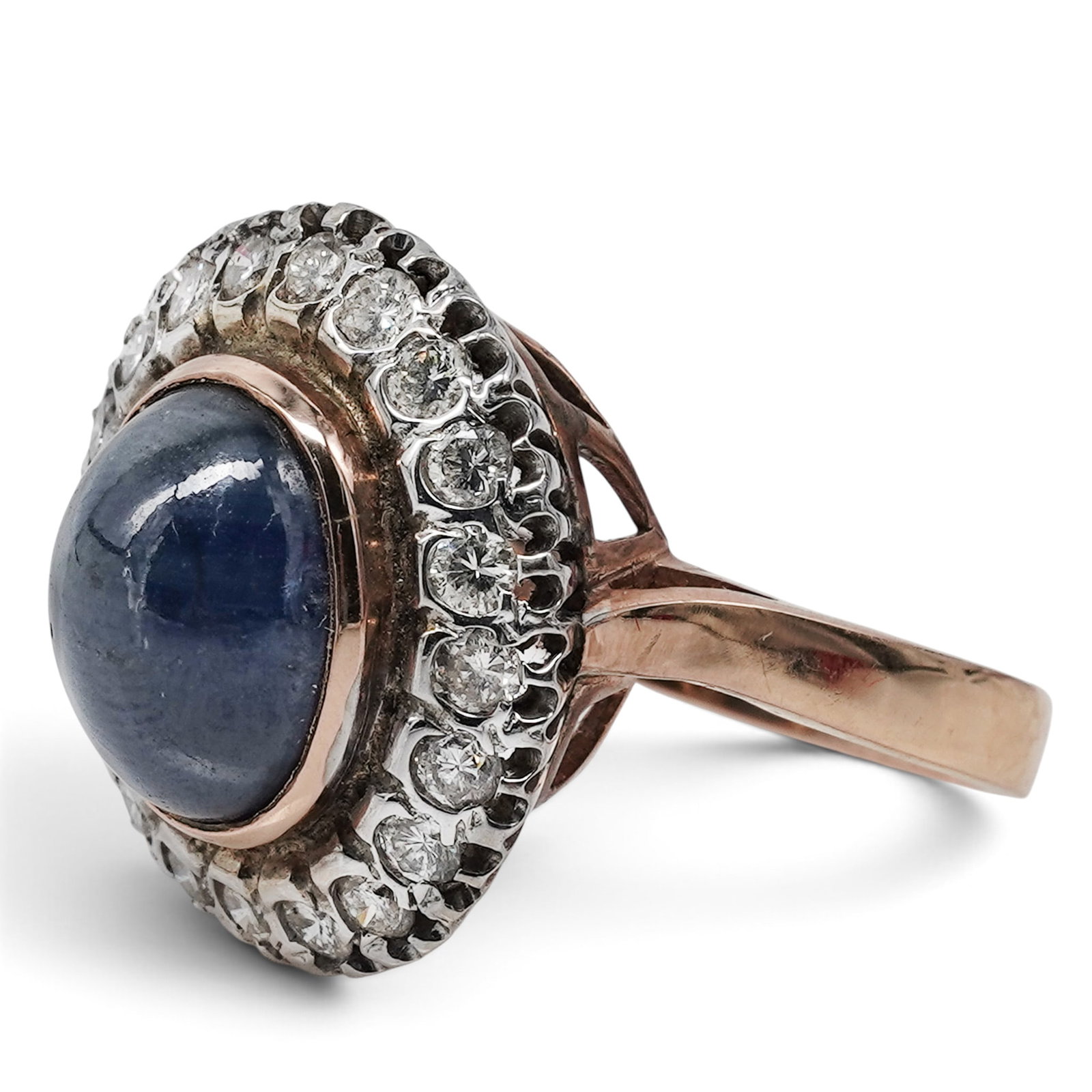 Vintage Soviet 14k Gold Platinum Sapphire & Diamond Cluster Ring: Vintage Soviet 14k Gold Platinum Sapphire & Diamond Cluster Ring 1960s-1980s, Russian Featuring an approximately 12 x 9 x 6mm oval cabochon natural sapphire in a 14k gold bezel, surrounded by approxim