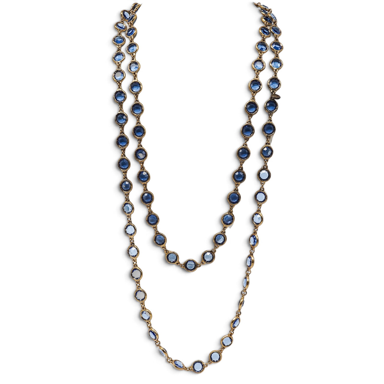 Chanel Gold-Tone & Sapphire Color Crystal Necklace: Chanel Gold-Tone & Sapphire Color Crystal Necklace 1981. French Vintage Chanel gold-tone long station necklace featuring faceted oval and rectangular Sapphire colored crystals in textured bezel settin