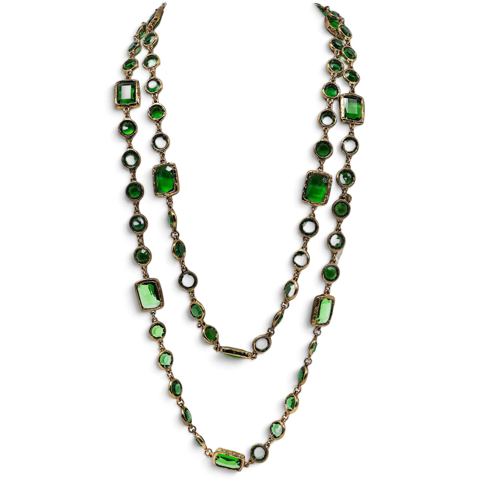 Chanel Gold-Tone Green Crystal Necklace: Chanel Gold-Tone Green Crystal Necklace 1981. French Vintage Chanel gold-tone long station necklace featuring faceted oval and rectangular amethyst-colored crystals in textured bezel settings. Hallmar