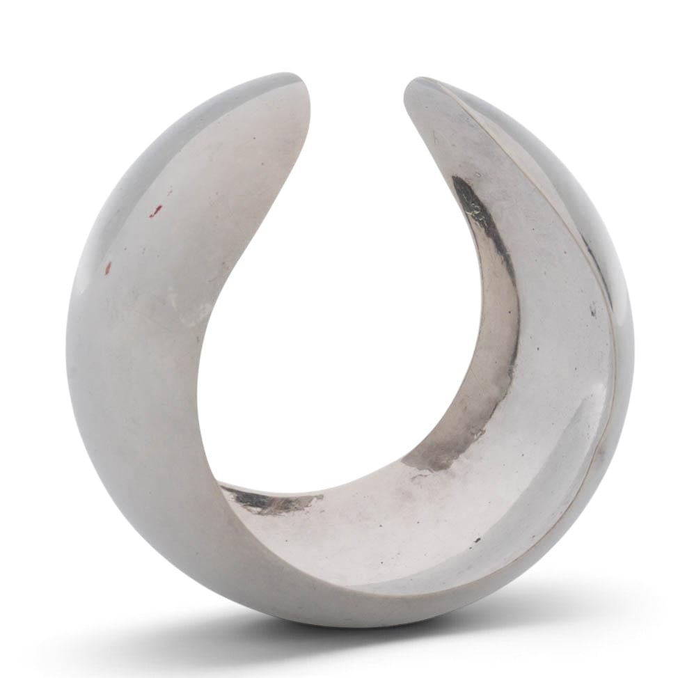 Modernist Mexican Sterling Silver Cuff: Modernist Mexican Sterling Silver Cuff 20th century, Mexican A Mexican sterling silver cuff. Marked on band "Mexico TV-55 925". Size 6.5"-6.75" Total weight: 66.3 grams. Diameter 3" x W 2.25"