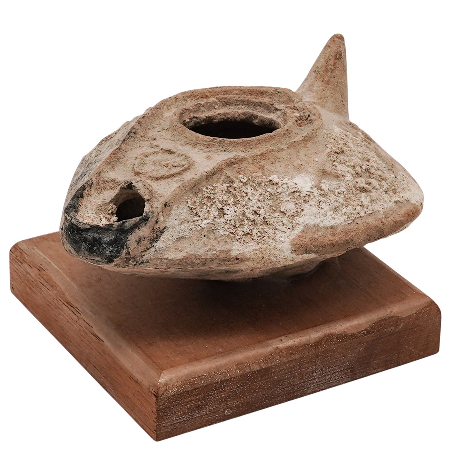 Ancient Byzantine Terracotta Oil Lamp: Ancient Byzantine Terracotta Oil Lamp approx. 5th to 7th century CE, Byzantine Empire Molded from a coarse, earthenware clay, this classic slipper-shaped domestic vessel features a wide, central circu