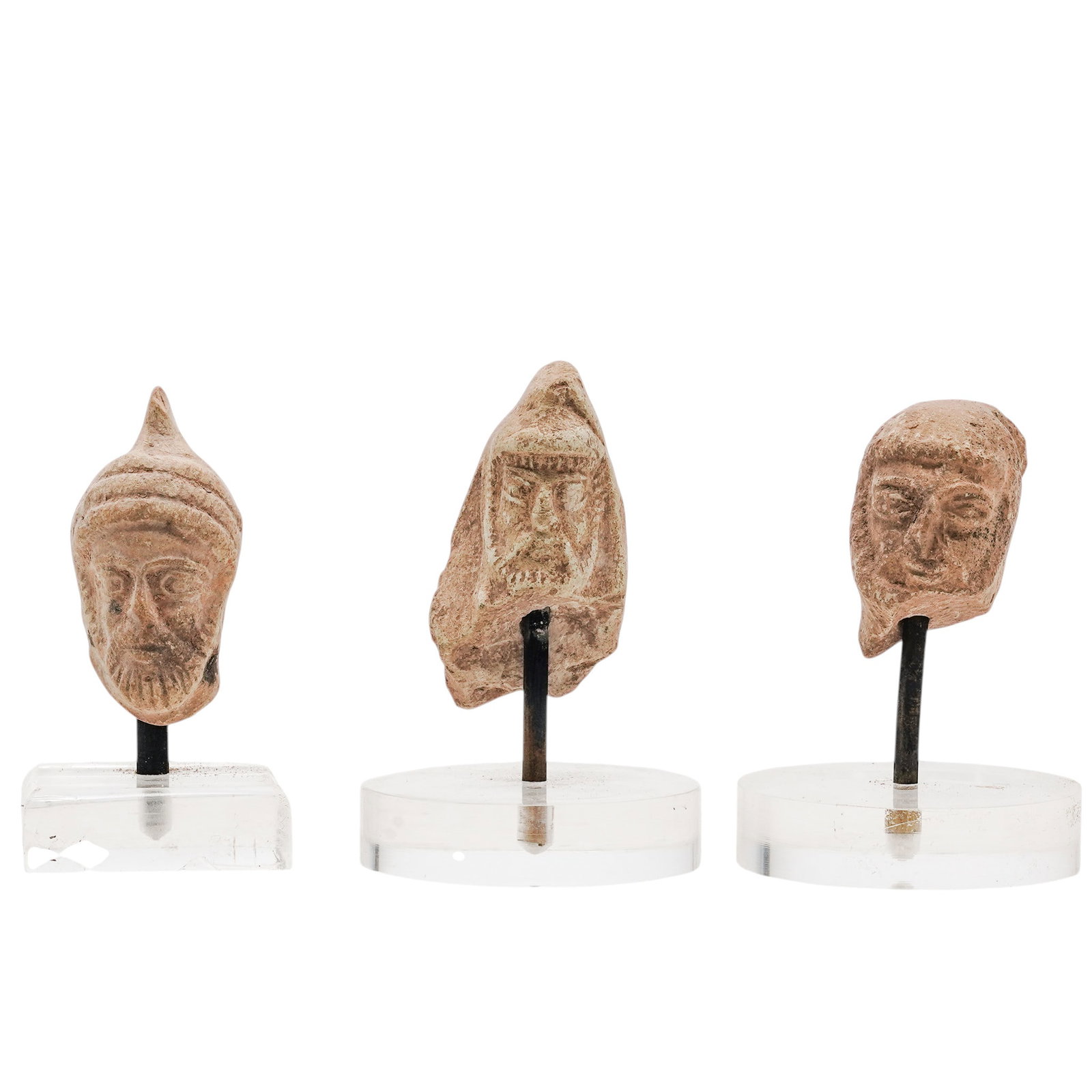 (3 pc) Middle Eastern Terracotta Heads: (3 pc) Middle Eastern Terracotta Heads c. 5th Century BCE-3rd Century CE, Mesopotamia Three small, mold-made terracotta male heads showcasing the distinct military, royal, and votive iconography of th