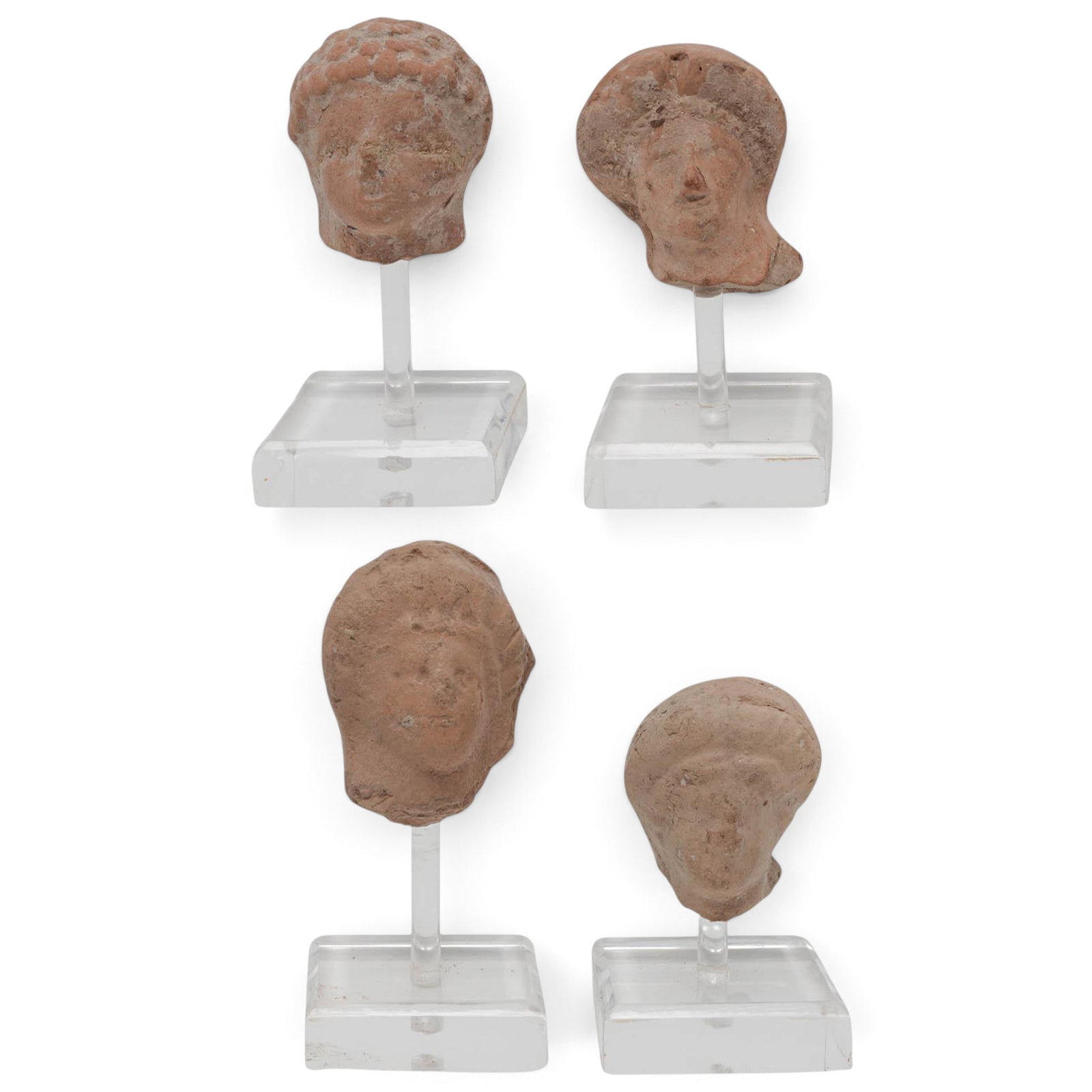 (4 pc) Ancient Greek Hellenistic Terracotta Female Heads: (4 pc) Ancient Greek Hellenistic Terracotta Female Heads Approx. c. 4th-2nd centuries B.C., Ancient Greece A fine collection of four ancient Greek mold-made terracotta miniature female heads, dating t