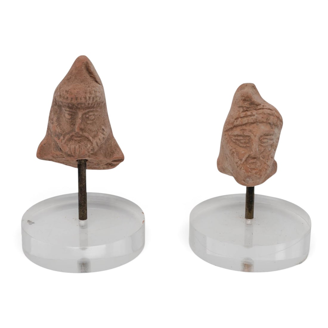 (2 pc) Ancient Persian Terracotta Heads: (2 pc) Ancient Persian Terracotta Heads Approx. c. 5th Century B.C.-2nd Century A.D., Ancient Iran This lot comprises a pair of ancient mold-made terracotta miniature heads explicitly depicting Persia