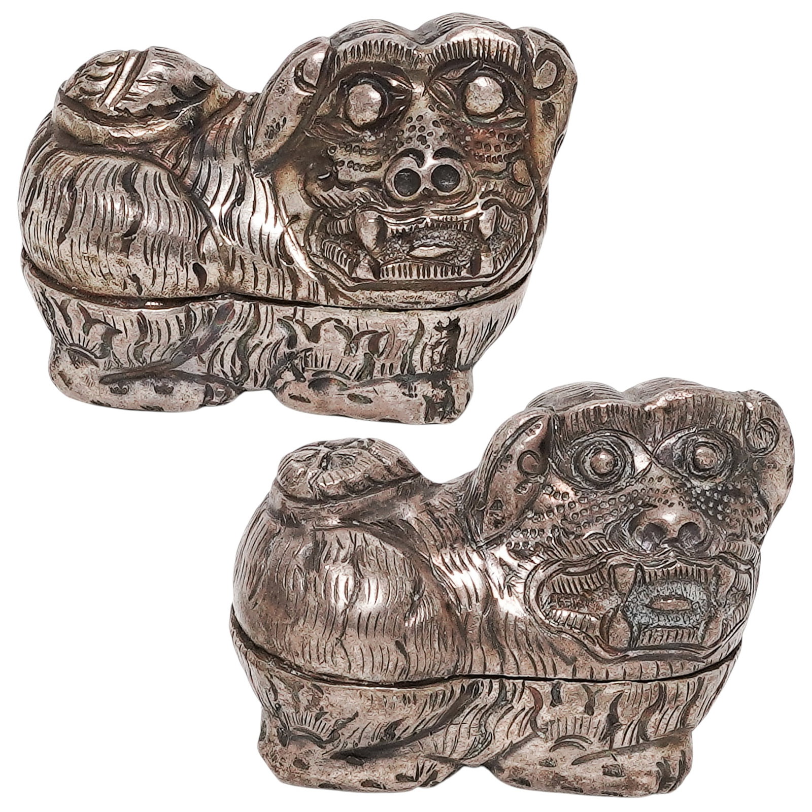 (2) Khmer Silversmiths 900 Silver Cambodian Foo Dogs Boxes: (2) Khmer Silversmiths 900 Silver Cambodian Foo Dogs Boxes 20th century, Cambodia Pair of 900 Silver Foo Dog Boxes Detailed, hand-tooled figurines form featuring engraved feathers and a two-piece holl