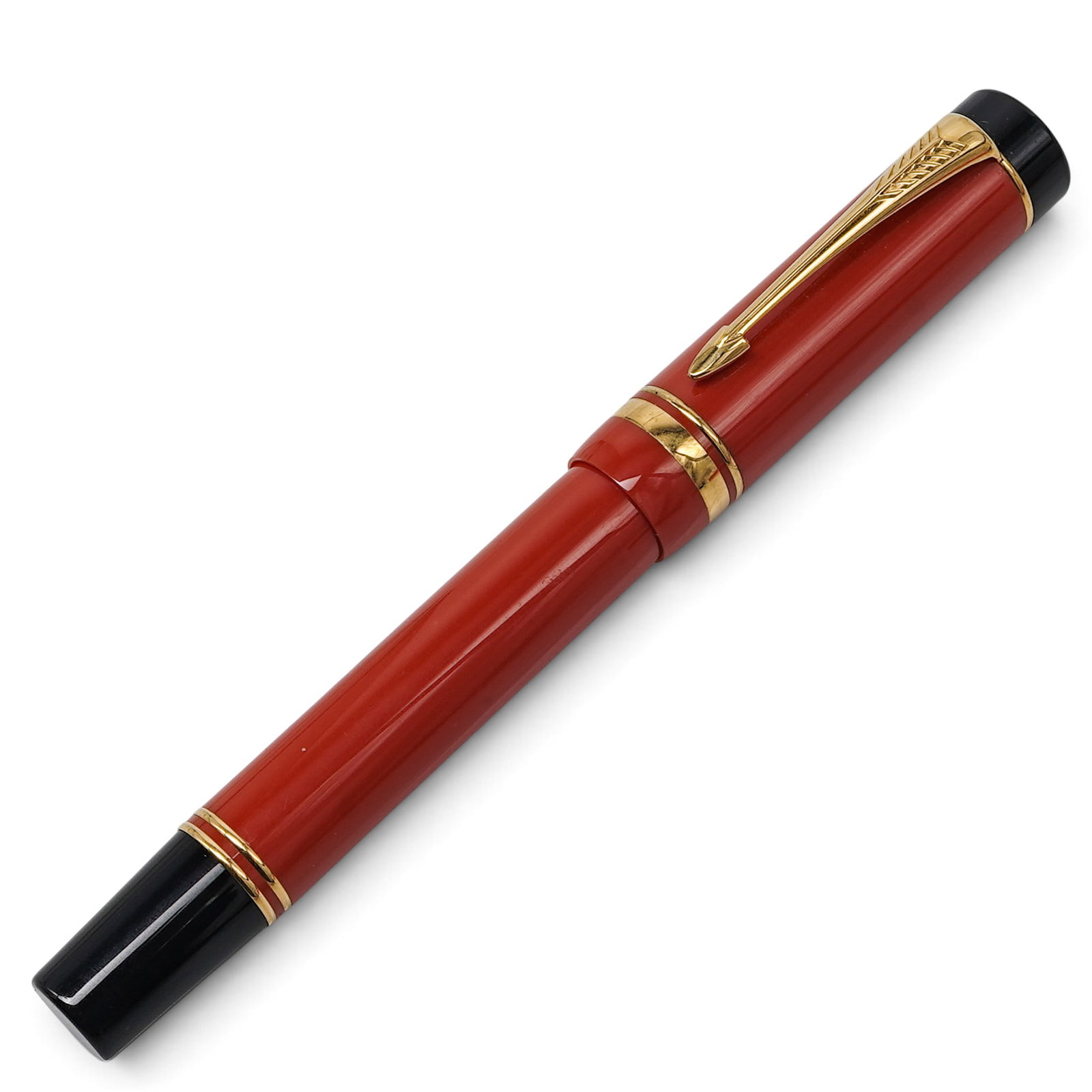 Parker Duofold Fountain Pen with 18k Gold Nib: Parker Duofold Fountain Pen with 18k Gold Nib Late 20th Century, English Orange resin fountain pen with black cap finials and gold-tone trim, fitted with an 18k gold nib. Twist cap design with arrow c