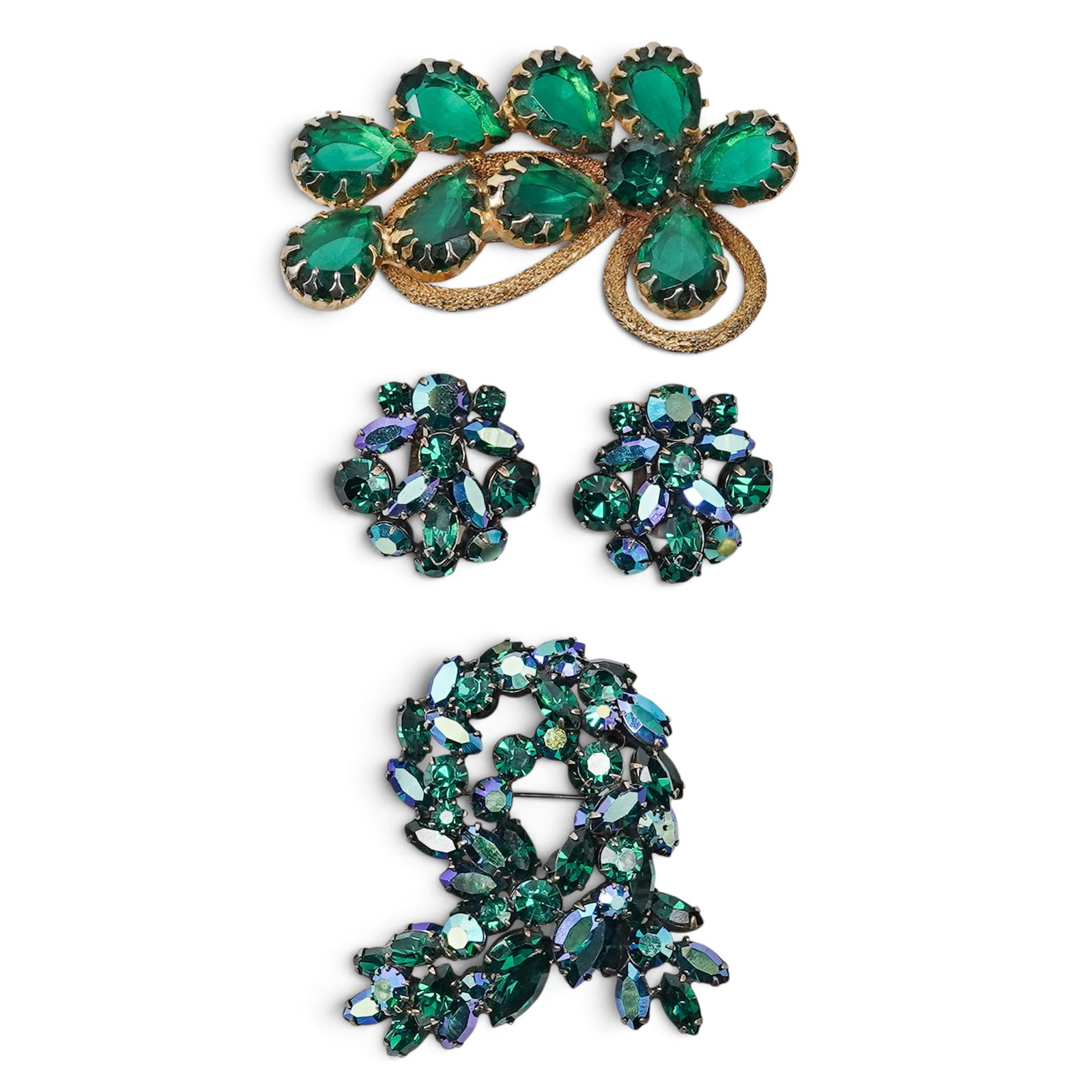 (3pc) Vintage Accessory Collection: The collection includes: (1)Swirled Green & Aurora Borealis Wreath Brooch. Marked "Regency" on verso. Diameter: 2 1/2" (2)Matching Cluster Clip-On Earrings. Diameter: 1 1/8" (1)Asymmetrical Emerald-Gr