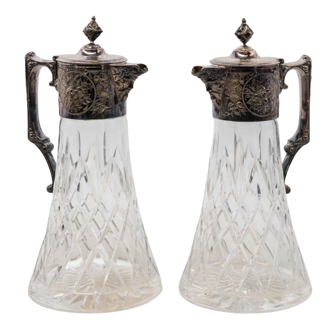 Pair Sterling Silver Mounted Atlantis Crystal Claret Jugs: Pair Sterling Silver Mounted Atlantis Crystal Claret Jugs 20th Cent, Portugal This pair of Atlantis crystal claret jugs features finely cut crystal bodies with intricate floral motif silver-mounted ne