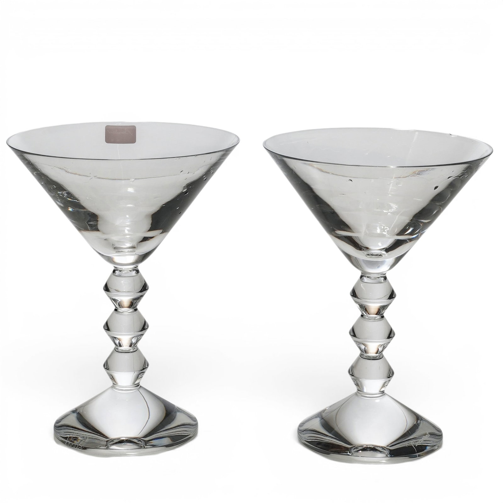 Pair Baccarat Vega Martini Crystal Glasses: Pair Baccarat Vega Martini Crystal Glasses Late 20th - 21st Cent, France Pair of Baccarat Vega crystal martini glasses, each featuring faceted, stepped stem supporting a conical bowl. Each glass