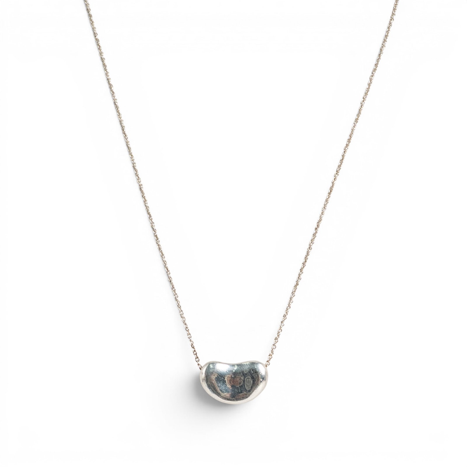 Elsa Peretti for Tiffany & Co. Sterling Silver Bean Pendant Necklace: Elsa Peretti for Tiffany & Co. Sterling Silver Bean Pendant Necklace 1990s, Italian Sterling silver necklace featuring Elsa Peretti's iconic Bean pendant suspended from a fine cable chain with spring 