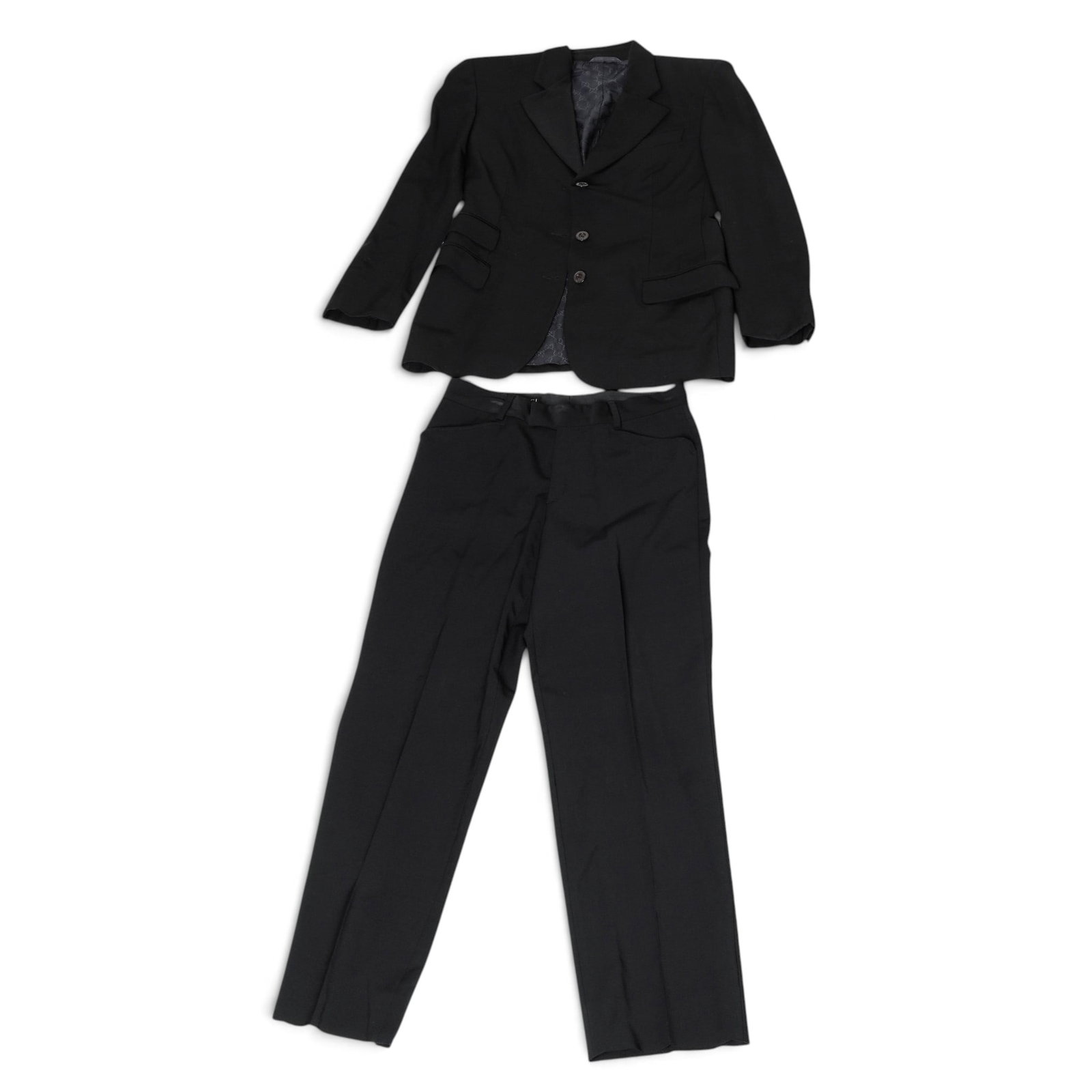(2 pc) Black Gucci Suit Set: (2 pc) Black Gucci Suit Set Late 20th century, Italy Two-piece black suit comprising a tailored three-button blazer and matching pleated trousers. The blazer features notch lapels, flap pockets, and a