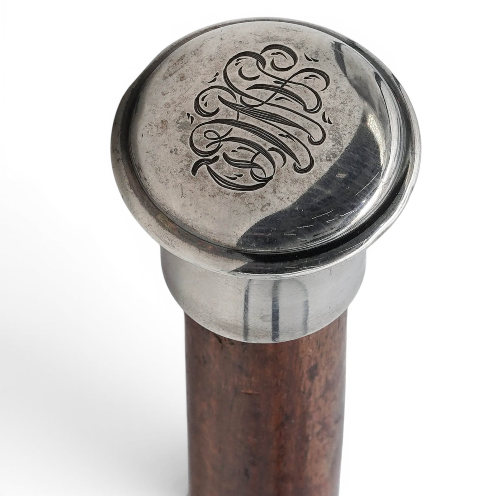 Antique Sterling & Wood Walking Stick: Antique Sterling & Wood Walking Stick Early 20th Cent. This antique walking cane features a polished silver-colored metal knob handle mounted onto a tapered wooden shaft. The smooth, rounded top of th