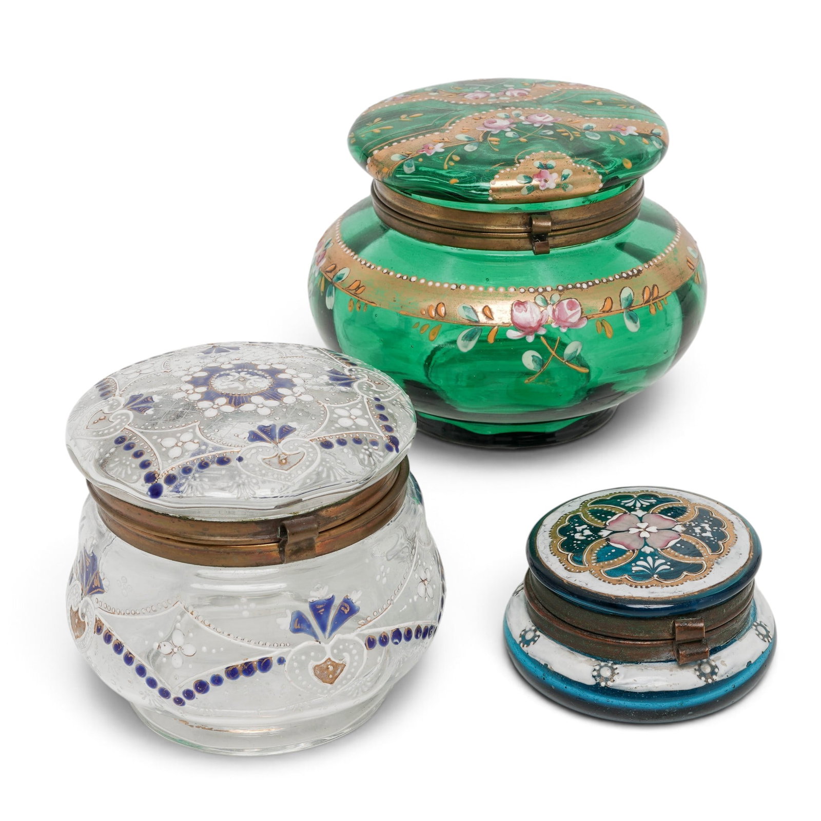 (3pc) Bohemian Glass Enameled Vanity Boxes: (3pc) Bohemian Glass Enameled Vanity Boxes 20th Cent.,Czech Republic The collection includes (1) Large green glass box featuring hand-painted floral panels with pink roses nestled between thick,