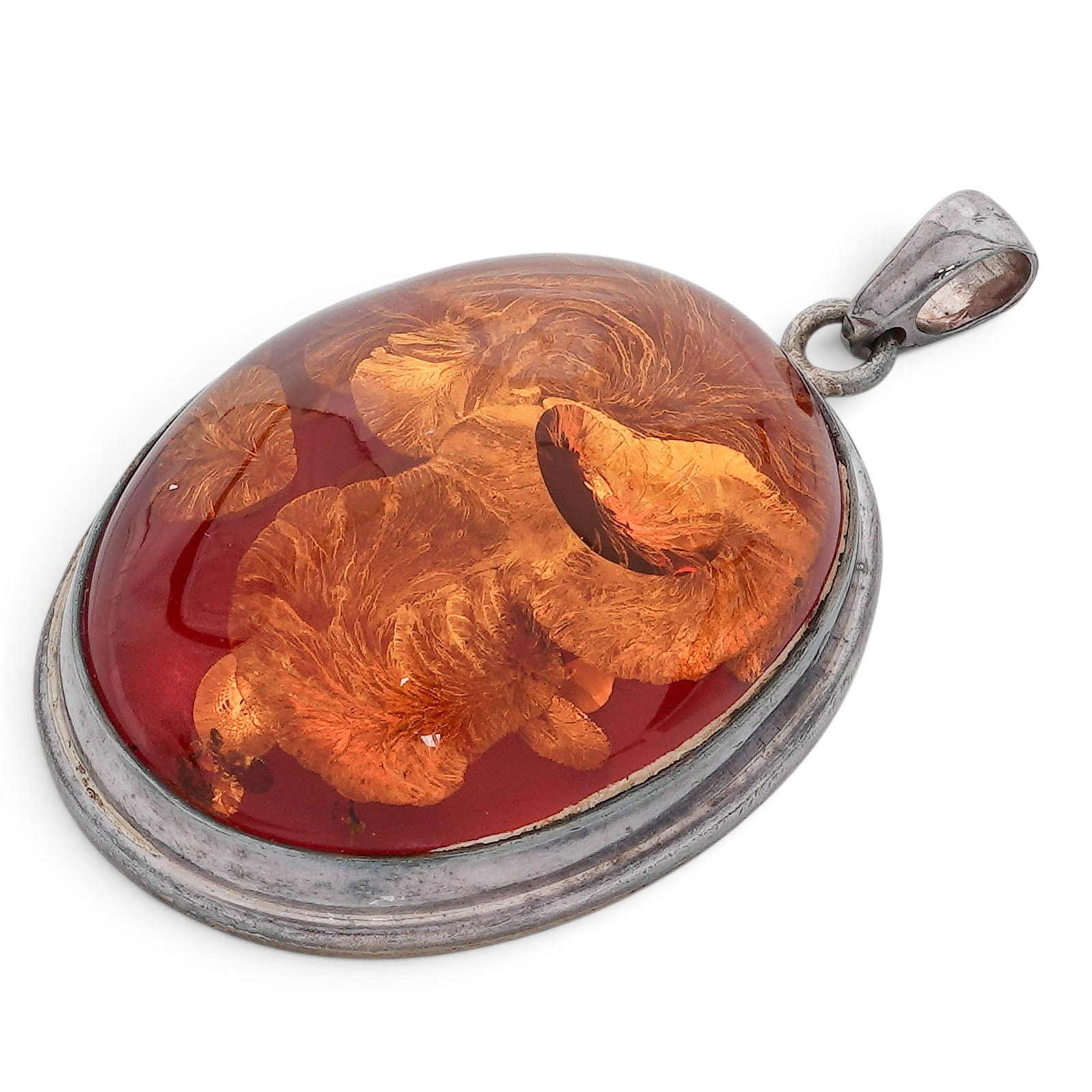 Large Baltic Amber Necklace Charm: Large Baltic Amber Necklace Charm 1970-1980, Baltic Republics Baltic amber necklace charm crafted with a polished, translucent oval stone set in a minimalist metallic frame. A large, dome-shaped (cabo