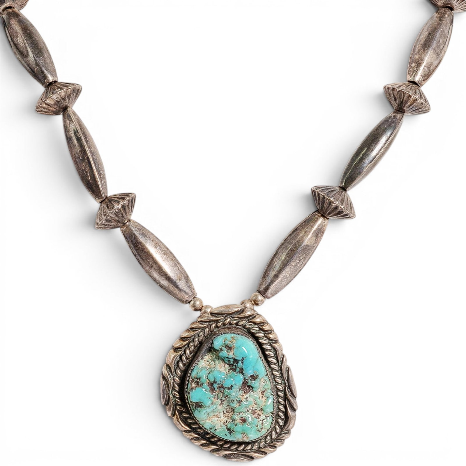 Vintage Dan Jackson Navajo Sterling Silver & Turquoise Pendant Necklace: Vintage Dan Jackson Navajo Sterling Silver & Turquoise Pendant Necklace 1970-1980s, USA Vintage sterling silver necklace by Dan A. Jackson, composed of various beads including melon, saucer, and elong