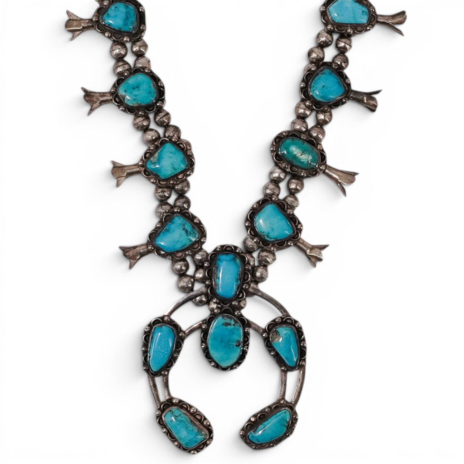 Vintage Navajo Sterling Silver & Turquoise Squash Blossom Necklace: Vintage Navajo Sterling Silver & Turquoise Squash Blossom Necklace 1970s-1980s, USA Vintage Navajo sterling silver squash blossom necklace featuring a large naja pendant with turquoise cabochons, matc