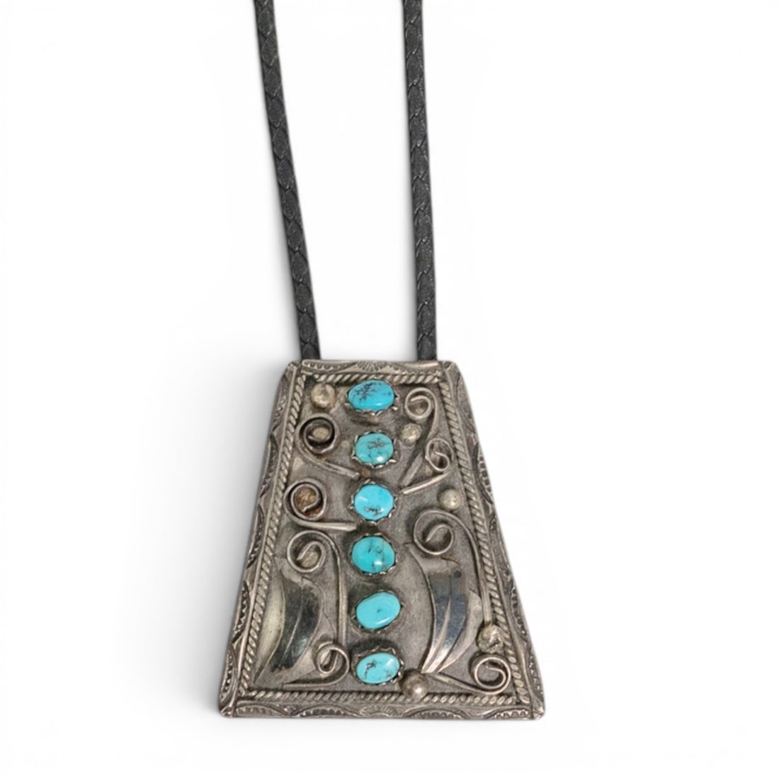 Vintage Navajo Sterling Silver & Turquoise Bolo Tie: Vintage Navajo Sterling Silver & Turquoise Bolo Tie 1970-1980s, USA Vintage Navajo sterling silver bolo tie set with six turquoise cabochons in serrated bezels, accented by twisted rope borders, appli