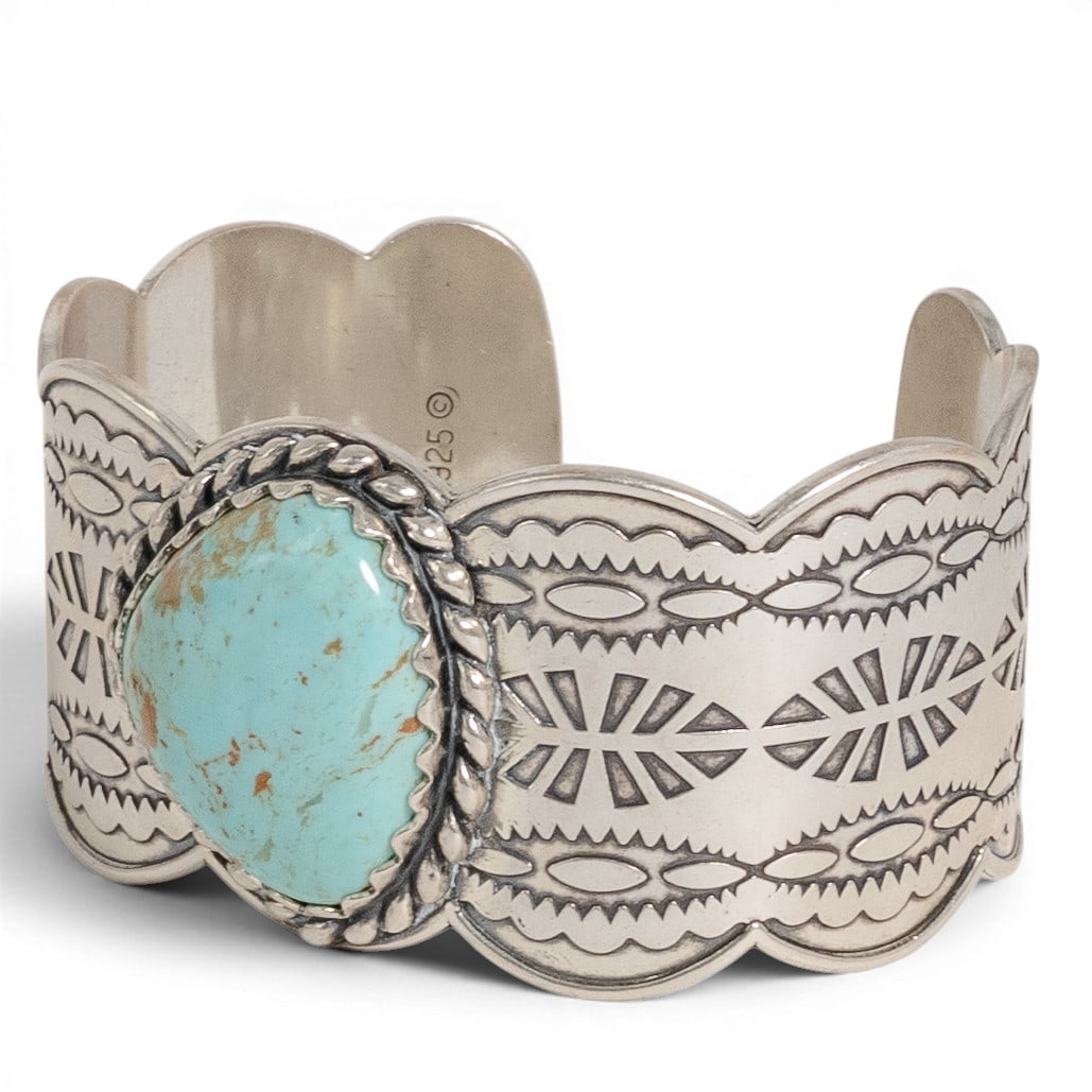 Carolyn Pollack for Relios Navajo Sterling Silver & Turquoise Cuff: Carolyn Pollack for Relios Navajo Sterling Silver & Turquoise Cuff 1970-1980s Vintage Navajo sterling silver cuff bracelet set with a turquoise cabochon in a serrated bezel, with twisted rope border a