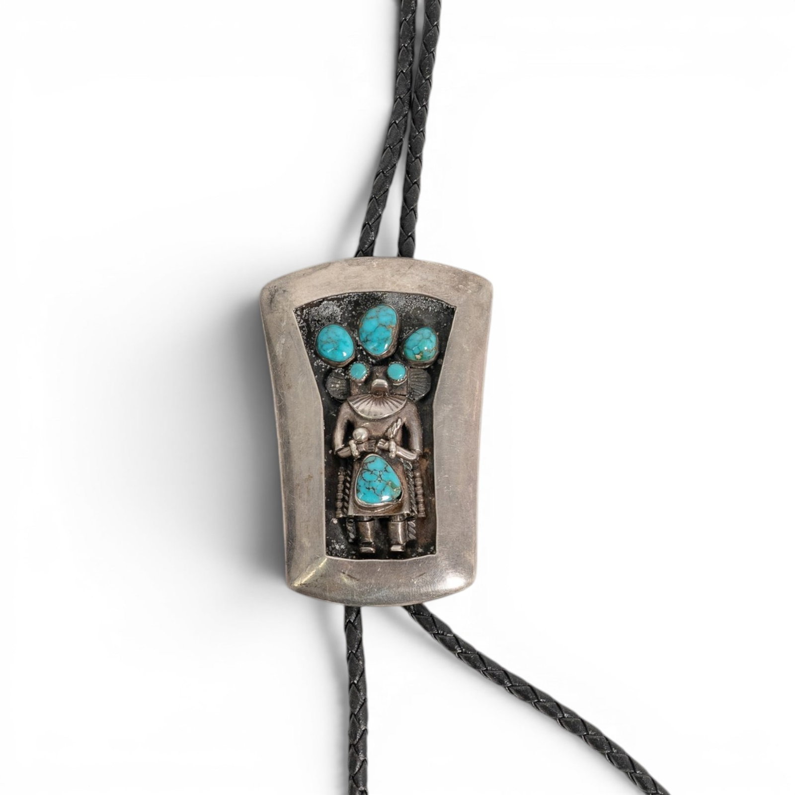 Vintage Navajo Sterling Silver & Turquoise Kachina Bolo Tie: Vintage Navajo Sterling Silver & Turquoise Kachina Bolo Tie 1970-1980s, USA Vintage Navajo sterling silver bolo tie featuring a dimensional Kachina figure set within a shadowbox-style rectangular fram