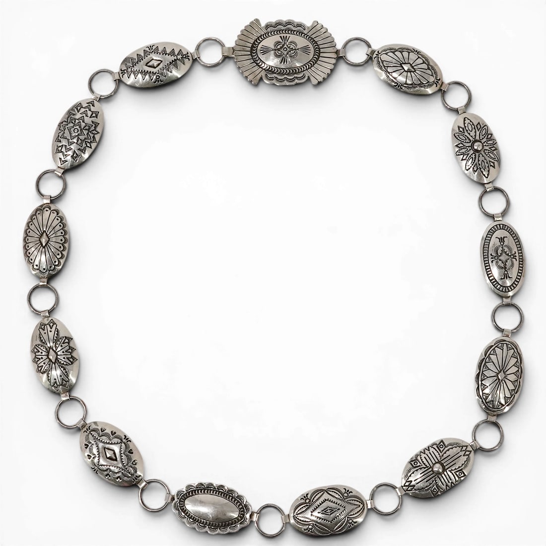 Vintage Navajo Vincent J. Platero Sterling Silver Stamped Concho Link Belt: Vintage Navajo Vincent J. Platero Sterling Silver Stamped Concho Link Belt 1970s-1980s, USA Vintage Navajo sterling silver concho link belt by Vincent J. Platero, featuring assorted stamped oval and s