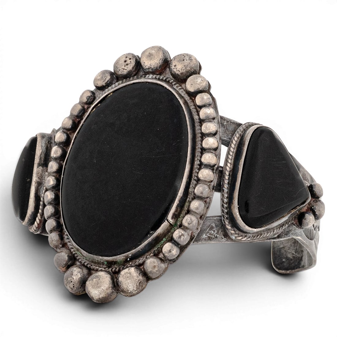 Vintage Navajo Sterling Silver & Onyx Three-Stone Cuff Bracelet: Vintage Navajo Sterling Silver & Onyx Three-Stone Cuff Bracelet 1970-1980s, USA Vintage Navajo sterling silver cuff bracelet featuring a large oval black onyx cabochon flanked by two triangular black 
