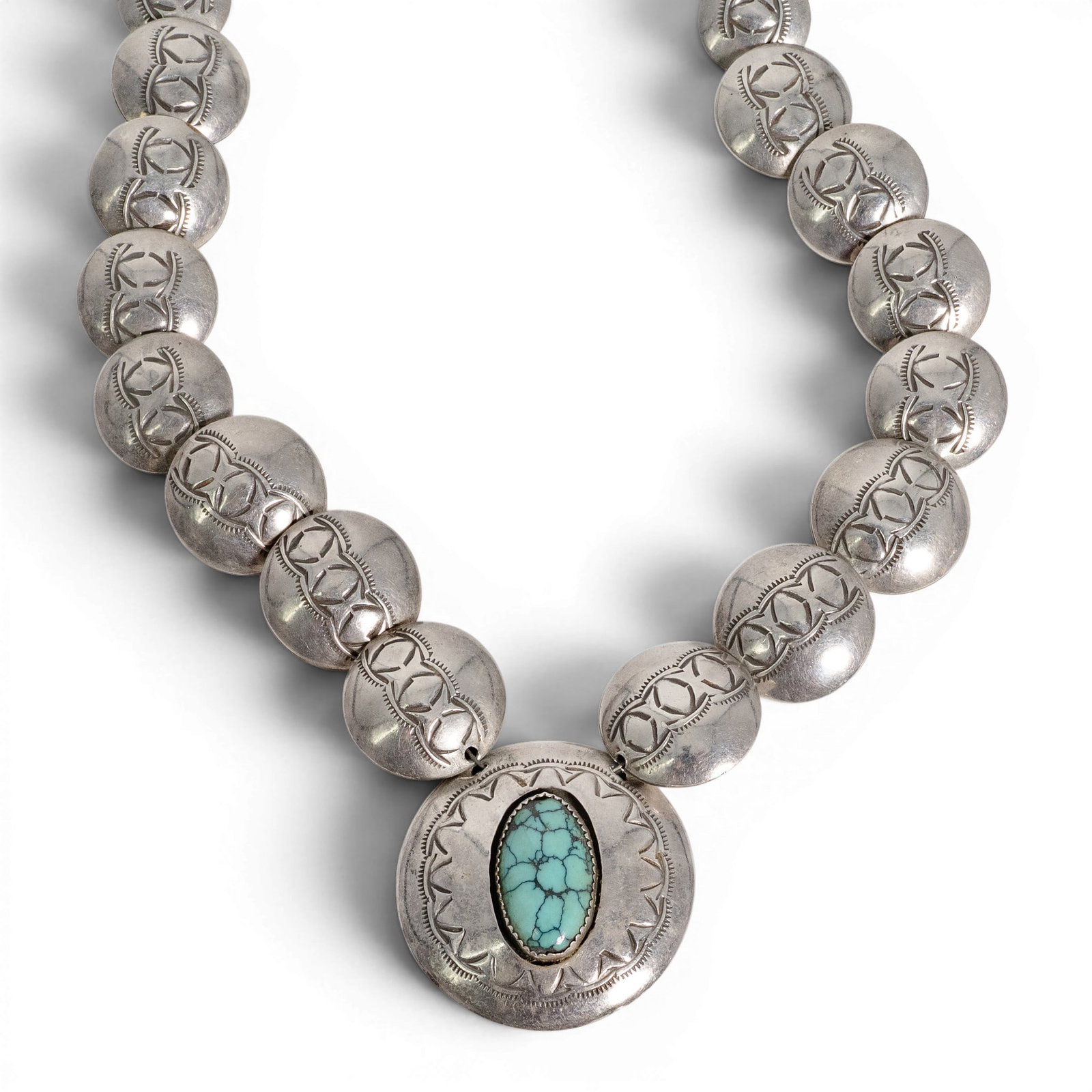 Vintage Navajo Sterling Silver & Turquoise Necklace: Vintage Navajo Sterling Silver & Turquoise Necklace 1970-1980s, USA Vintage Sterling silver necklace featuring graduating stamped hollow silver beads supporting a large circular pendant set with an ov