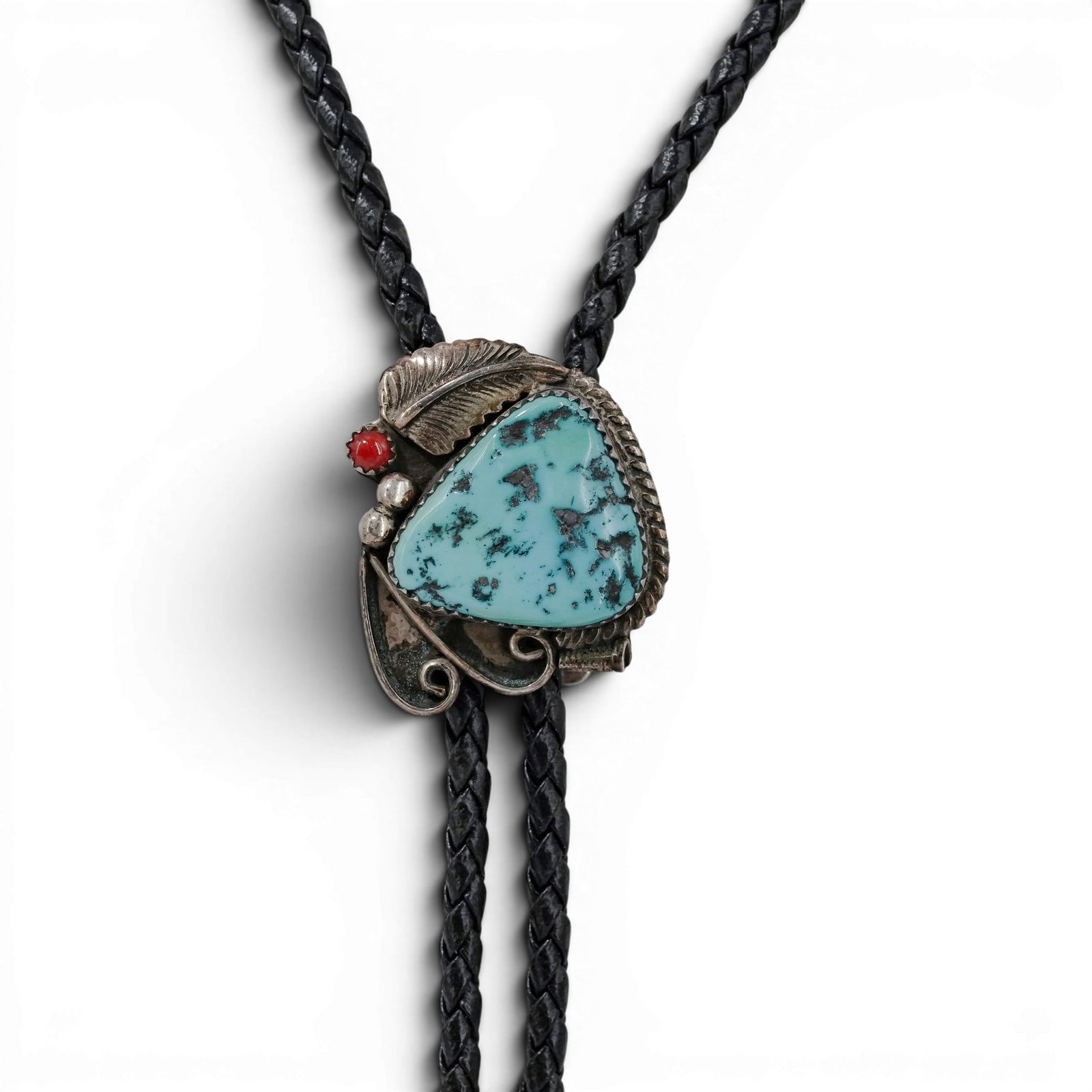 Vintage Navajo Sterling Silver Turquoise & Coral Bolo Tie: Vintage Navajo Sterling Silver Turquoise & Coral Bolo Tie 1970-1980s, USA Vintage sterling silver bolo tie featuring a large triangular turquoise cabochon accented by a small coral cabochon, feather m