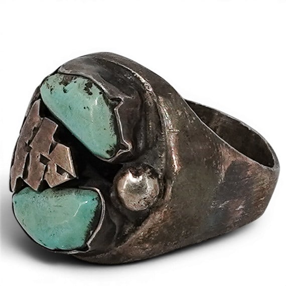 Vintage Navajo Sterling Silver & Turquoise Ring: Vintage Navajo Sterling Silver & Turquoise Ring 1970-1980s, USA Vintage Navajo sterling silver ring featuring two natural turquoise cabochons set within a bezel accented by a central hand-cut silver a