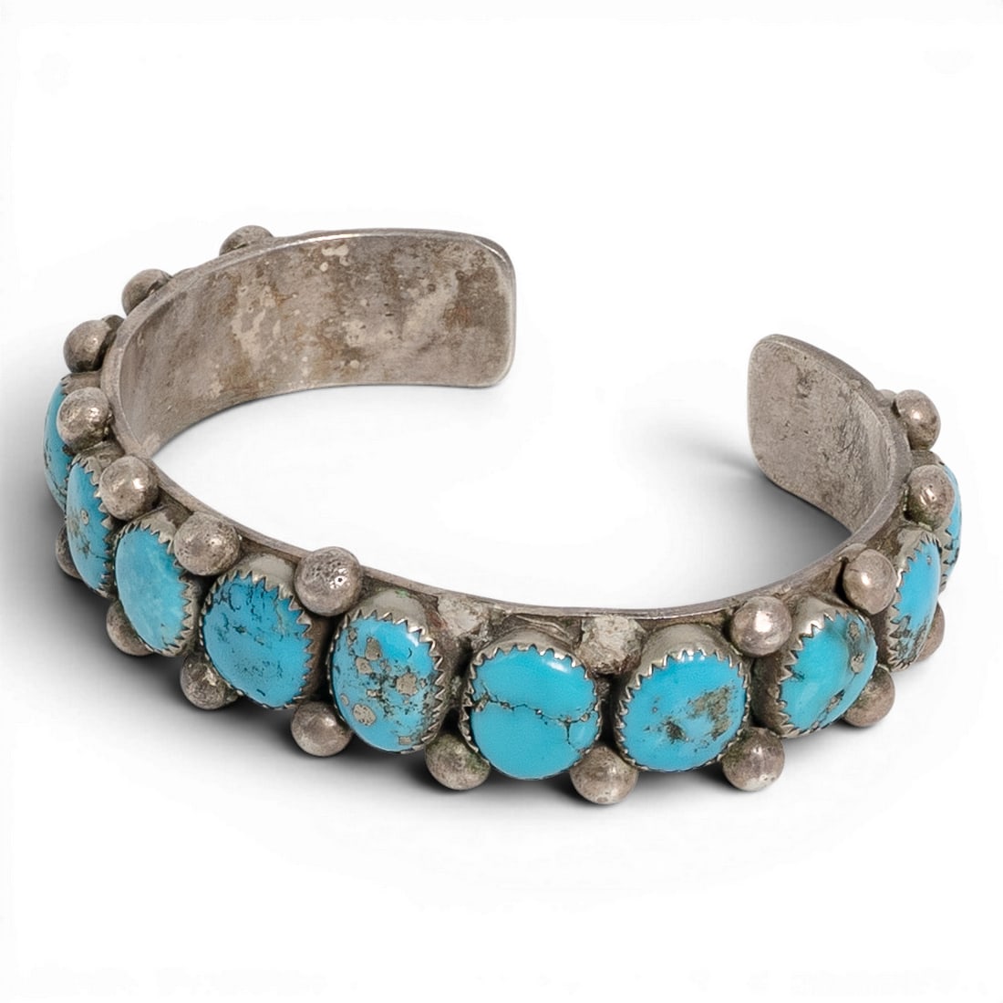 Vintage Navajo Sterling Silver & Turquoise Row Cuff Bracelet: Vintage Navajo Sterling Silver & Turquoise Row Cuff Bracelet 1970-1980s, USA Vintage Navajo sterling silver cuff bracelet featuring a vertical arrangement of fourteen natural turquoise cabochons, each