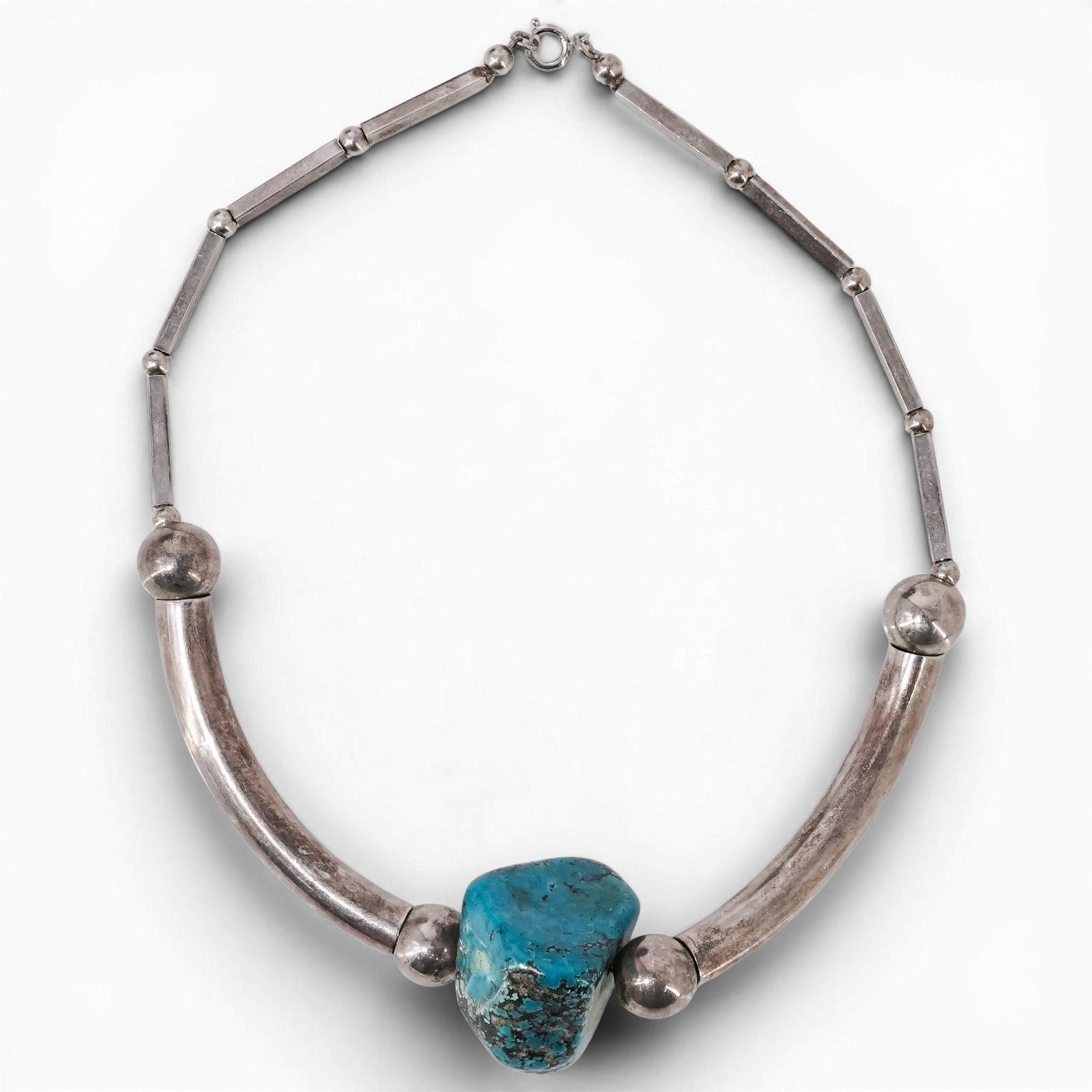 Vintage Navajo Sterling Silver & Turquoise Nugget Necklace: Vintage Navajo Sterling Silver & Turquoise Nugget Necklace 1970s-1980s, USA Vintage Navajo sterling silver necklace with large freeform turquoise nugget centerpiece, curved silver tube sections, round