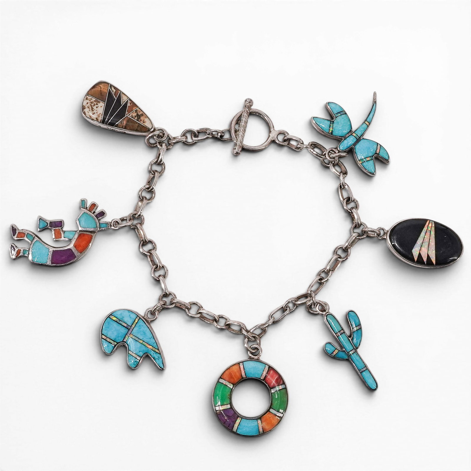 Silver Expressions Sterling Silver & Multi-Stone Inlay Charm Bracelet: Silver Expressions Sterling Silver & Multi-Stone Inlay Charm Bracelet Late 20th Century, Filipino Vintage sterling silver link charm bracelet by Silver Expressions featuring multiple Southwestern-styl