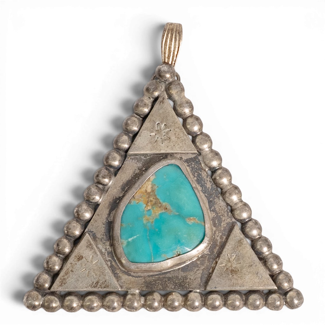 Vintage Navajo Sterling Silver & Turquoise Triangle Pendant: Vintage Navajo Sterling Silver & Turquoise Triangle Pendant 1970-1980s, USA Vintage sterling silver triangular pendant centered by a natural turquoise cabochon in a smooth bezel. Accented with hand-st