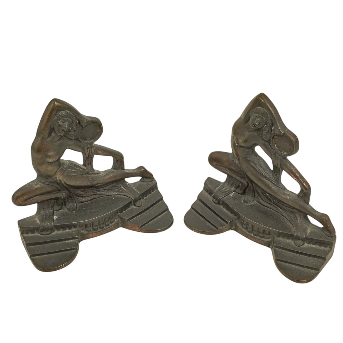 Pair of Art Deco Cast Iron 'Tambourine Dancer' Bookends: Pair of Art Deco Cast Iron 'Tambourine Dancer' Bookends Early 20th Century, USA Pair of Art Deco cast iron bookends depicting a stylized female tambourine dancer in a flowing costume and dynamic pose.