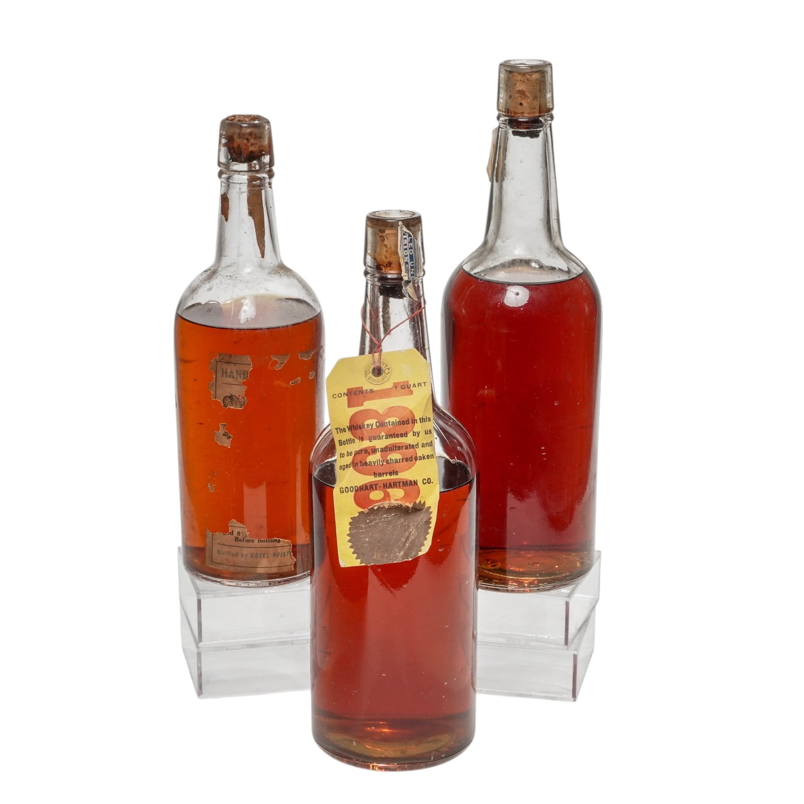 (3 pc) Vintage Goodhart-Hartman Co. Sealed Whiskey Bottles: (3 pc) Vintage Goodhart-Hartman Co. Sealed Whiskey Bottles c. 1915-1929, USA Goodhart-Hartman Co. was a prominent wholesale liquor dealer and distiller operating out of Chicago, Illinois, during the l